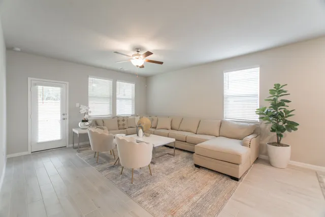 a living room with furniture and a large window