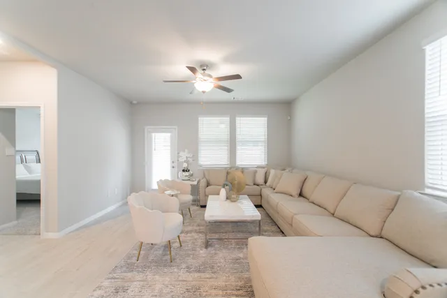a living room with furniture and a large window