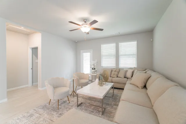 a living room with furniture and a large window