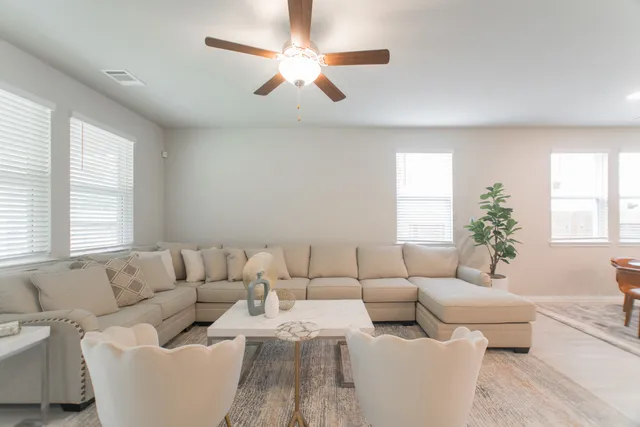 a living room with furniture and a large window