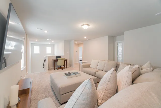 a living room with furniture white walls and white walls