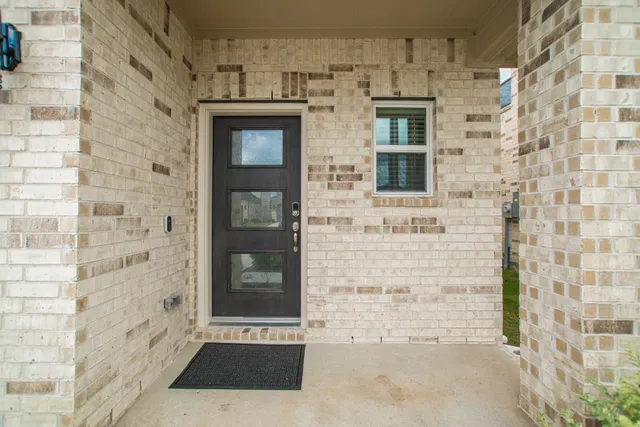 a view of a brick house with a large window