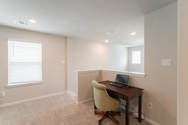 a workspace with furniture and a window