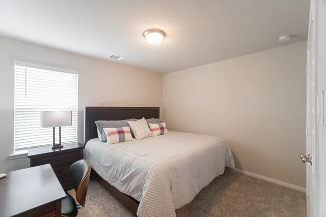 a bedroom with a bed and a window