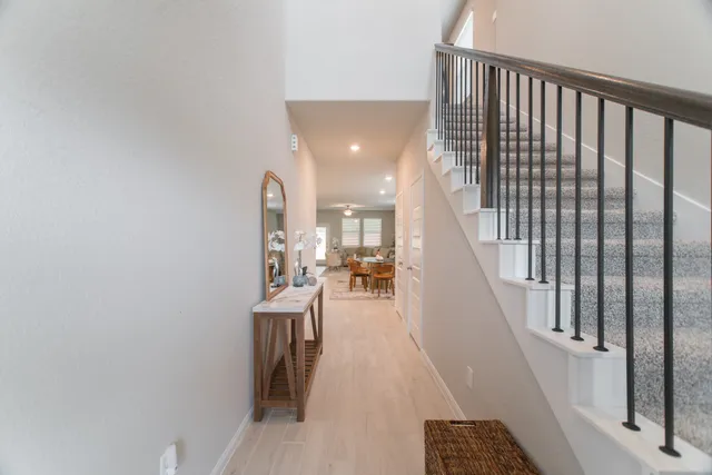 a view of entryway and hall with wooden floor