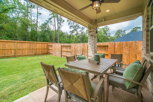 a view of an outdoor dining space with a table and chairs