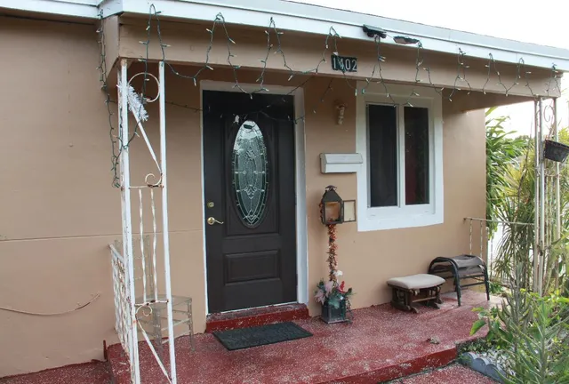 a front view of a house with outdoor seating