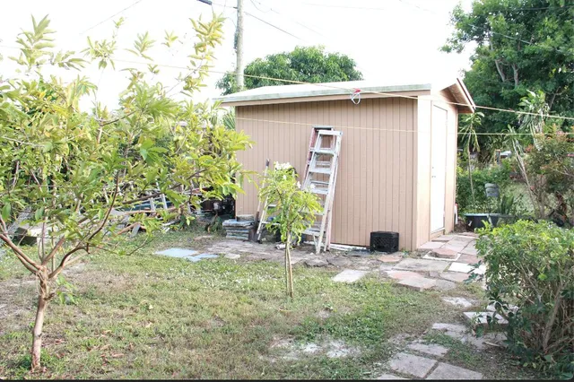 a backyard of a house with table and chairs