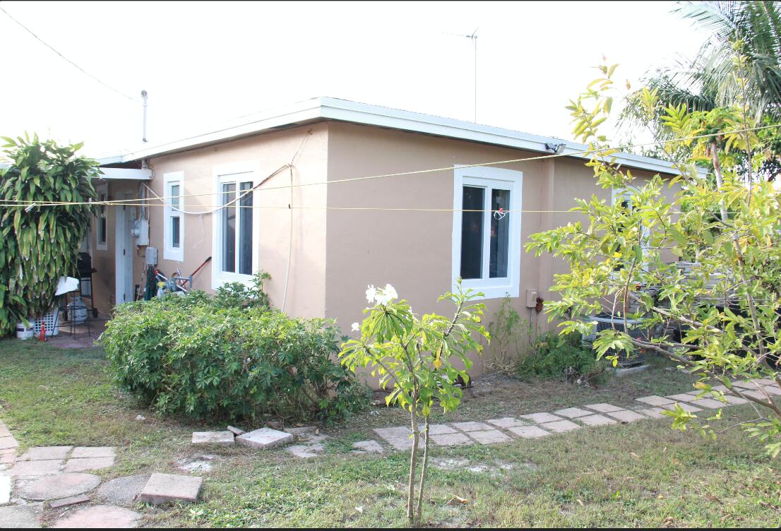 1402 South C Street Lake Worth Beach, FL 33460 - Photo 15 of 27 a front view of a house with garden