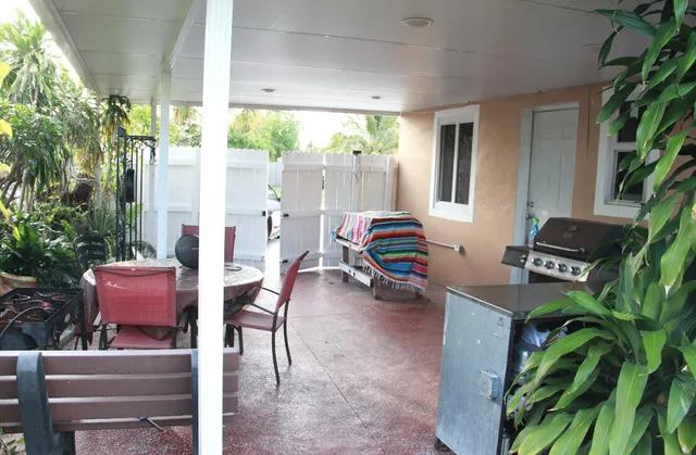 a view of a workspace with furniture and a potted plant