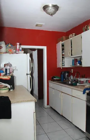 a kitchen with stainless steel appliances granite countertop a sink dishwasher stove top oven and cabinets