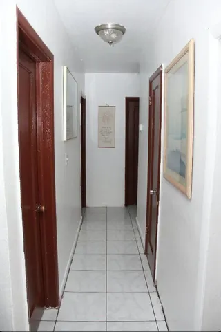 a view of hallway with closet and a bathroom