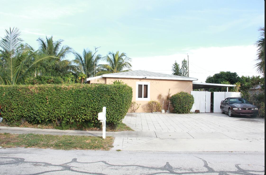 1402 South C Street Lake Worth Beach, FL 33460 - Photo 4 of 27 a view of a house with a yard and potted plants