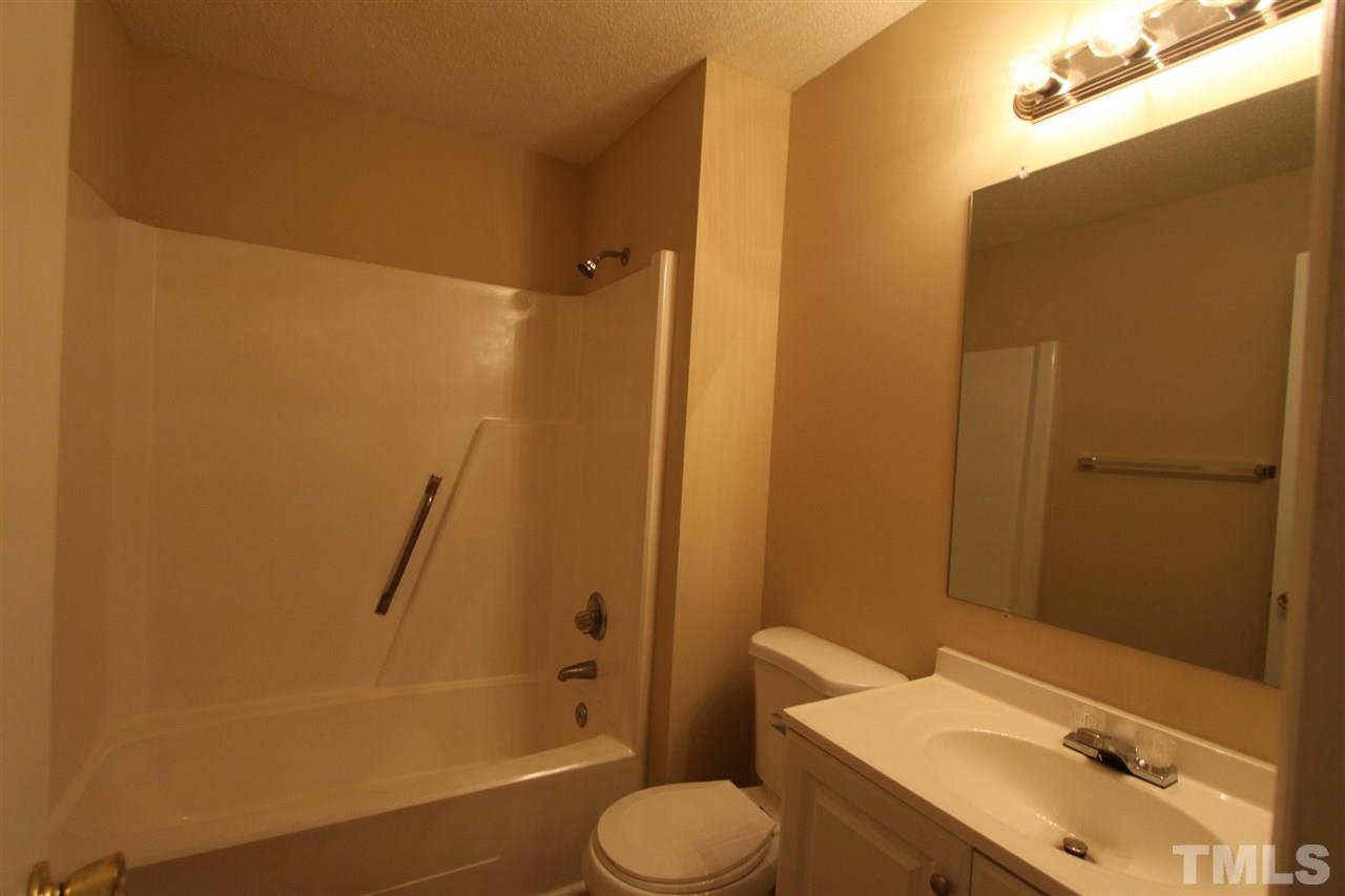 845 Horton Road Durham, NC 27704 - Photo 8 of 14 a bathroom with a sink toilet and shower