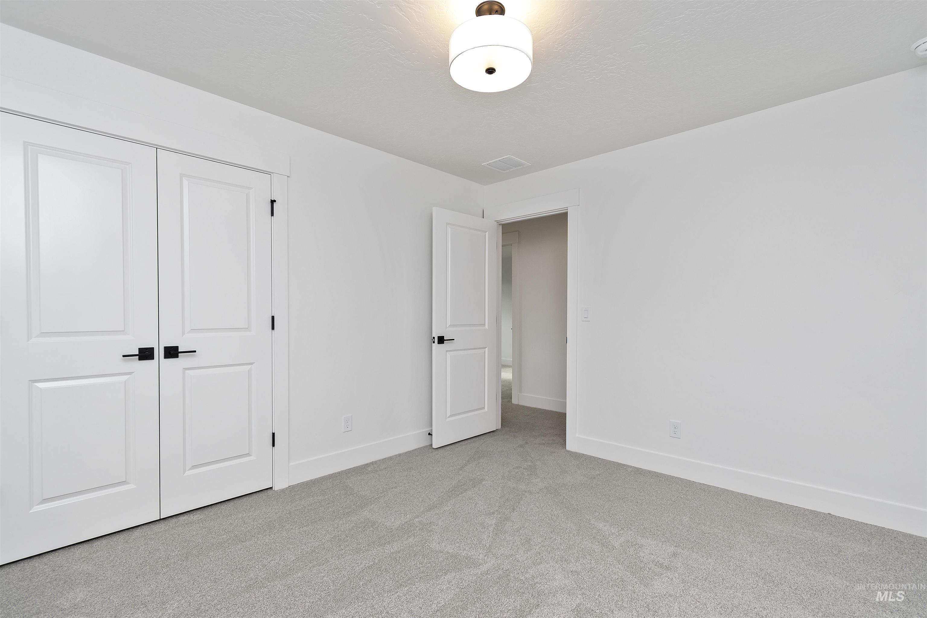 764 South Calhoun Lane Star, ID 83669 - Photo 36 of 48 Unfurnished bedroom featuring carpet flooring and a closet