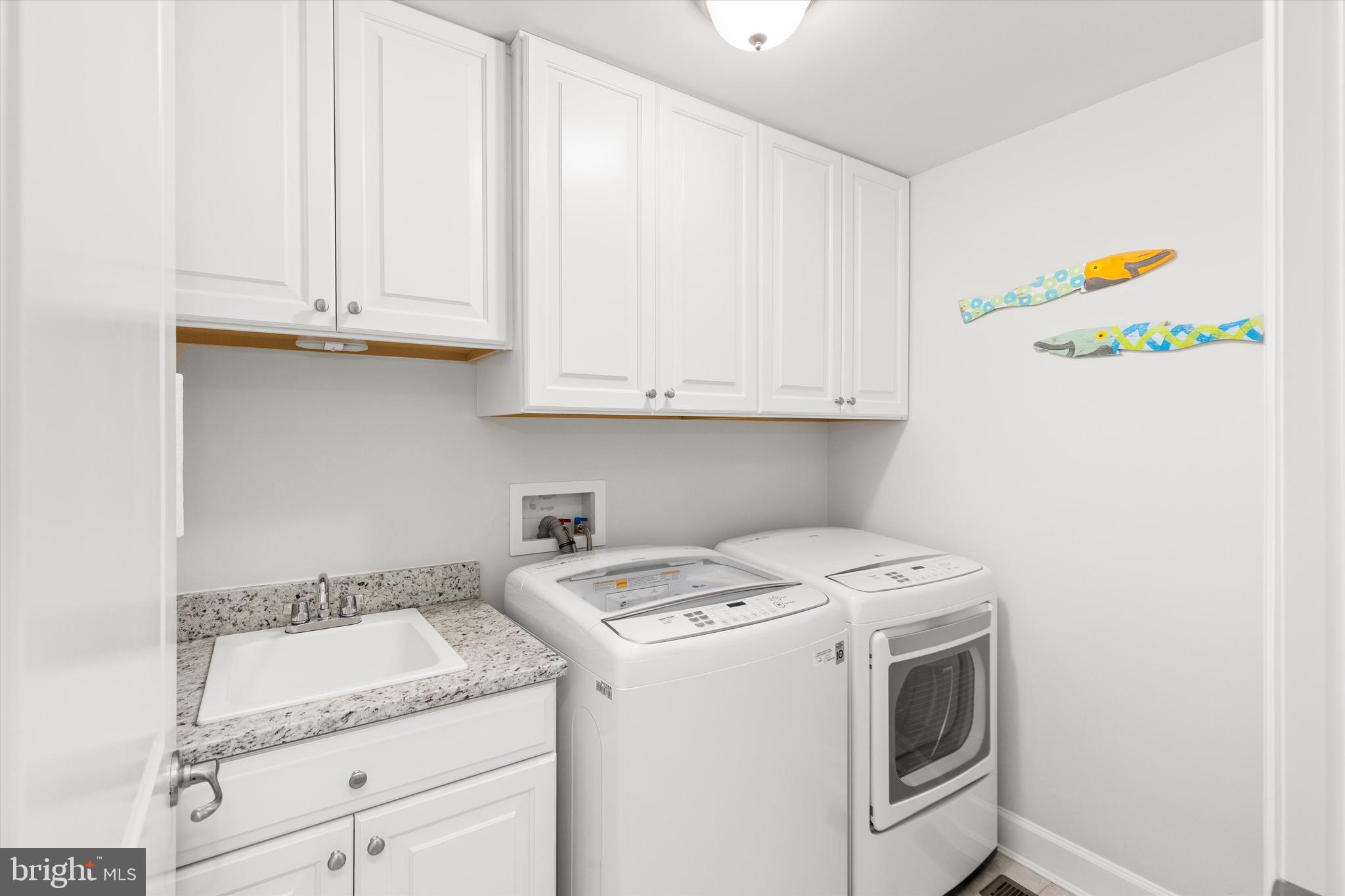 23549 Robalo Road Frankford, DE 19945 - Photo 40 of 53 1st Floor Laundry w/ lots of Cabinets and Sink
