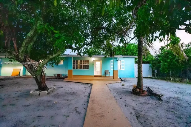 a view of a backyard with a tree