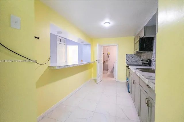 a large bathroom with a sink a mirror and a bathtub