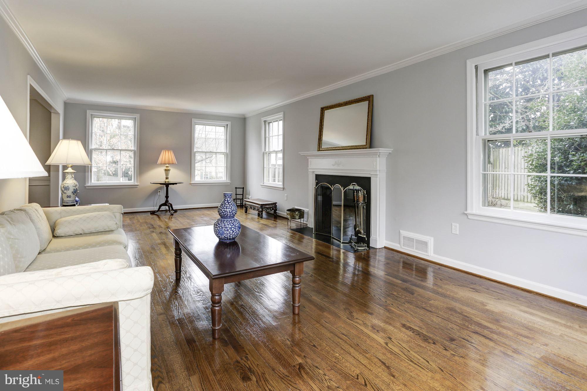 6015 Overlea Road Bethesda, MD 20816 - Photo 7 of 30 a living room with fireplace furniture and a wooden floor