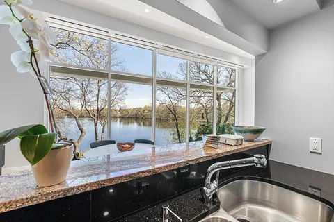 a dining table sitting next to a large window
