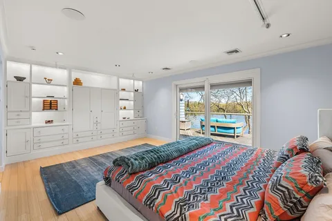 a bedroom with a bed and a large window