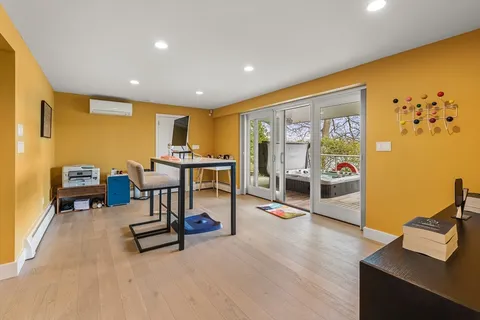 a living room with furniture a rug and a flat screen tv