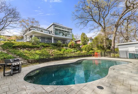 a swimming pool with outdoor seating and yard