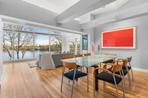 a dining room with furniture and wooden floor