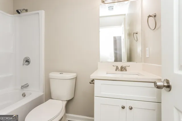 a bathroom with a toilet sink shower and mirror
