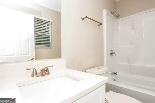 a bathroom with a sink a toilet and a bathtub