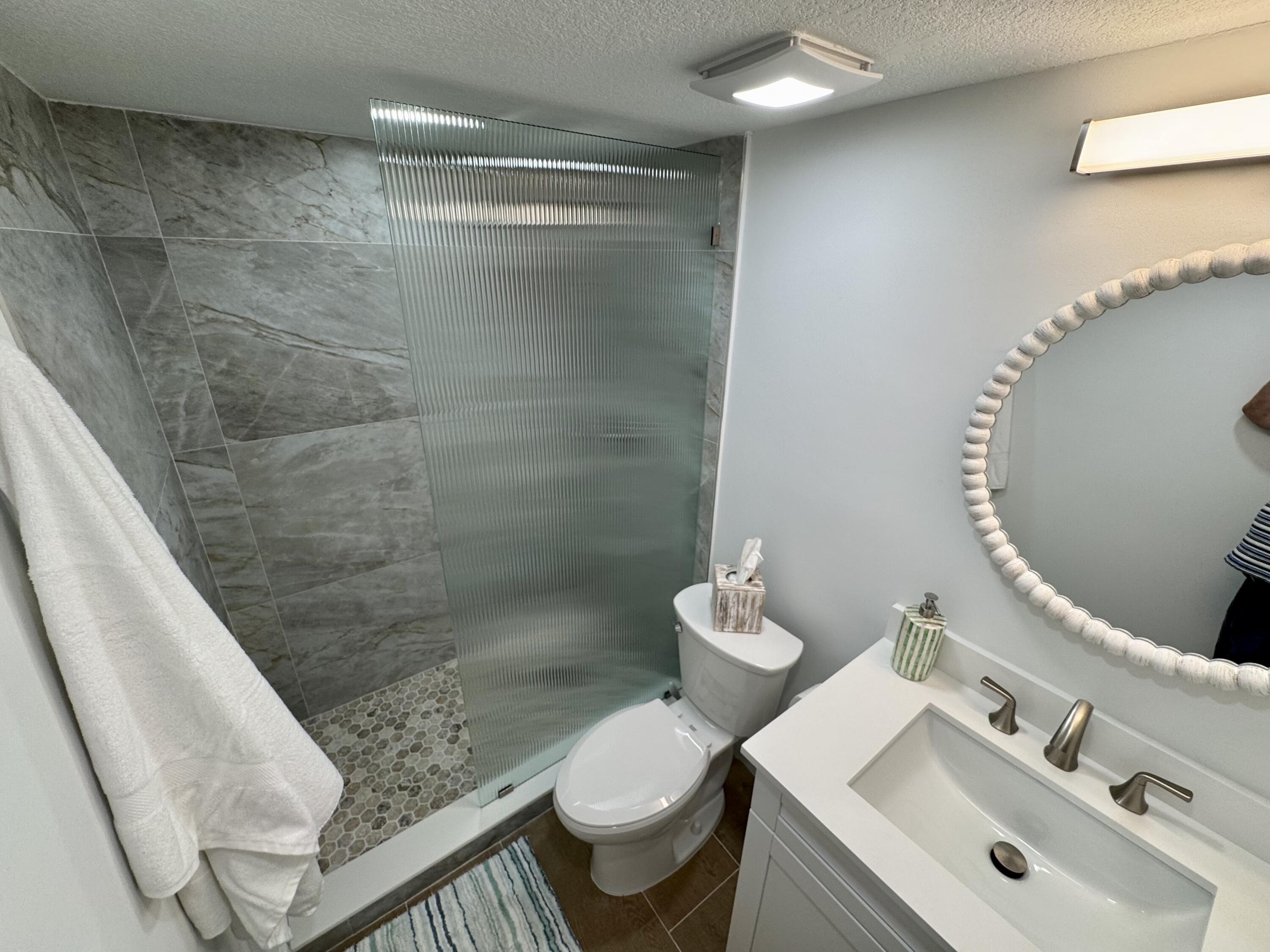 541 Normandy L Delray Beach, FL 33484 - Photo 10 of 55 a bathroom with a sink toilet and shower