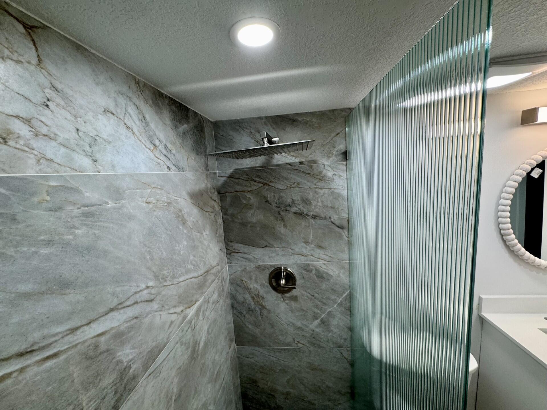 541 Normandy L Delray Beach, FL 33484 - Photo 11 of 55 a bathroom with a shower