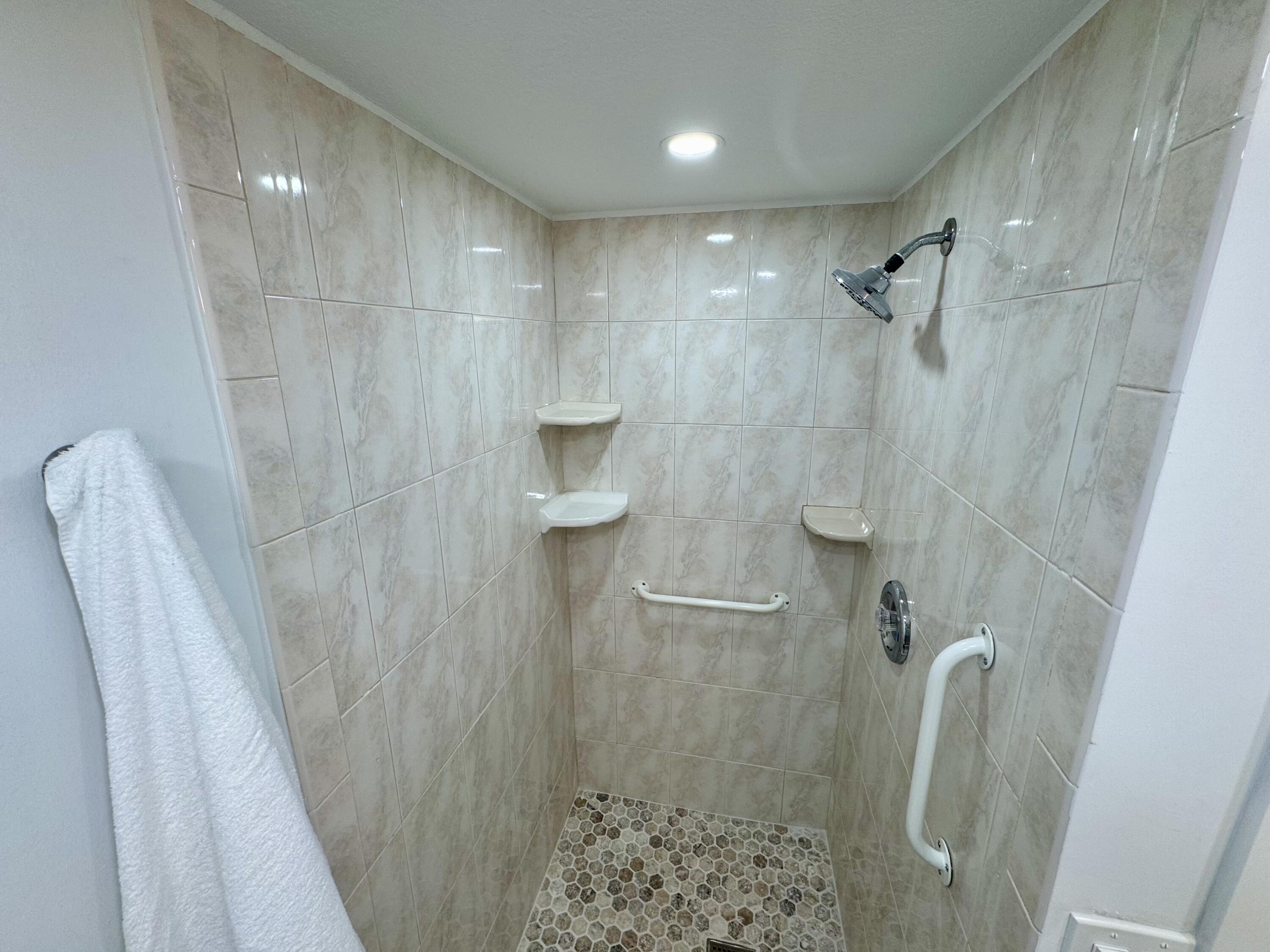 541 Normandy L Delray Beach, FL 33484 - Photo 14 of 55 a bathroom with a shower