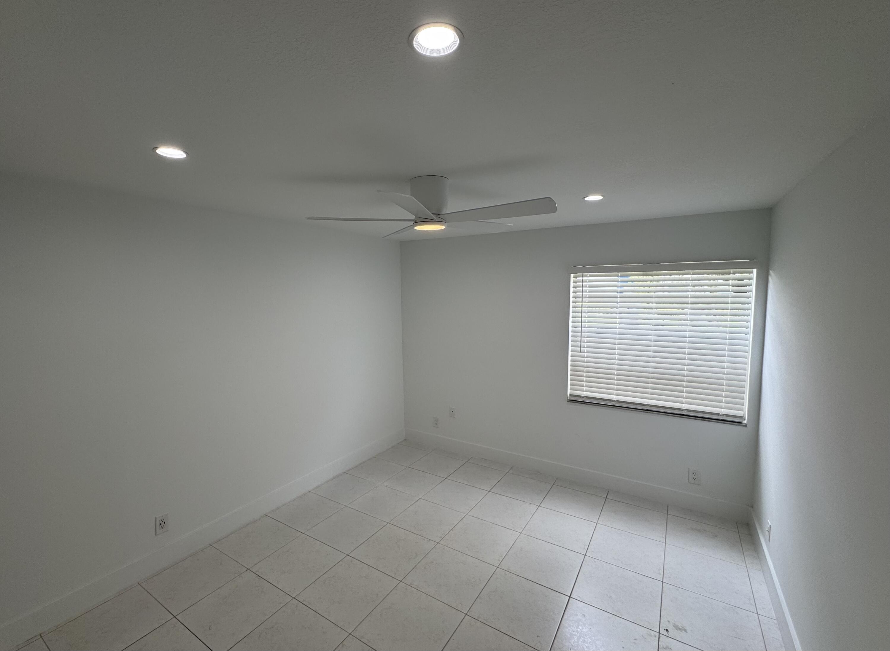 541 Normandy L Delray Beach, FL 33484 - Photo 16 of 55 an empty room with a empty space and windows