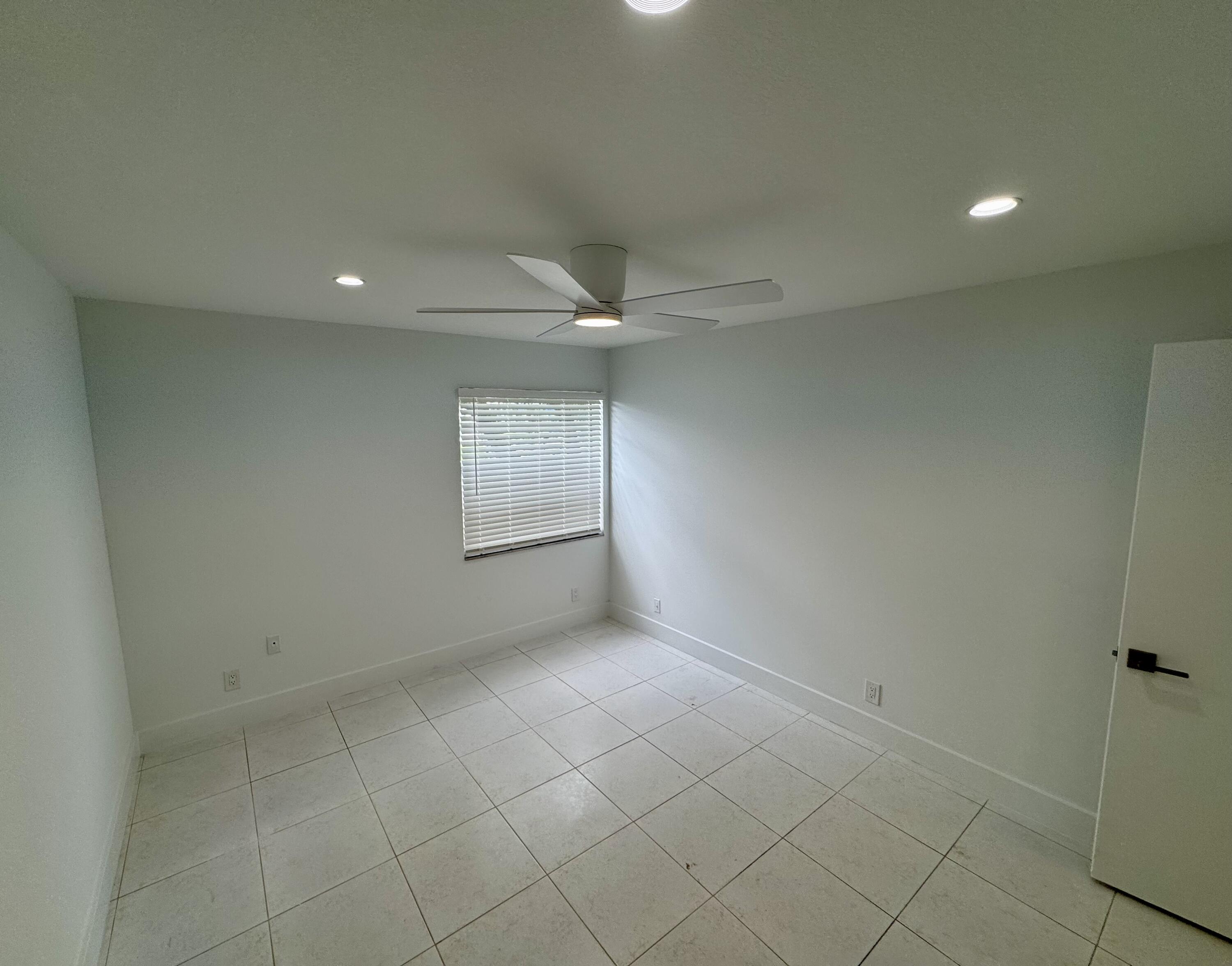 541 Normandy L Delray Beach, FL 33484 - Photo 17 of 55 an empty room with a empty space and windows