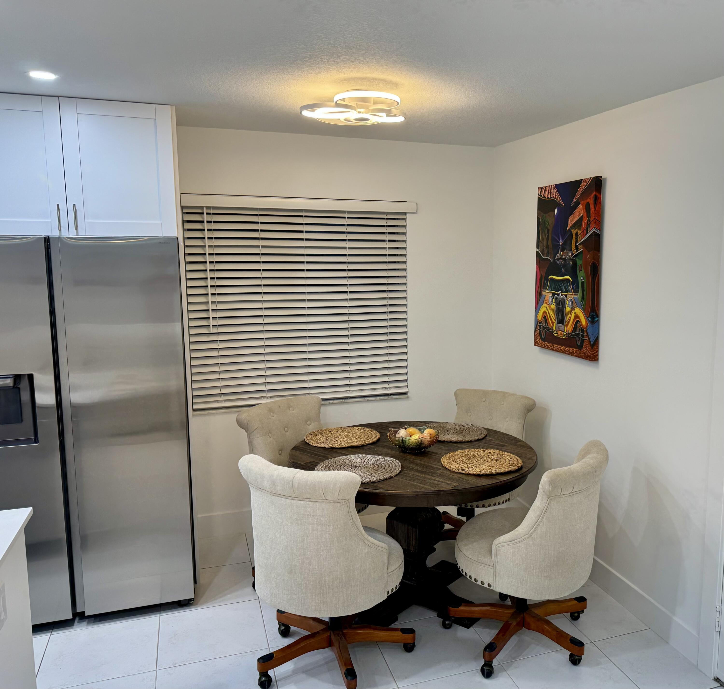 541 Normandy L Delray Beach, FL 33484 - Photo 5 of 55 a dining room with furniture and window