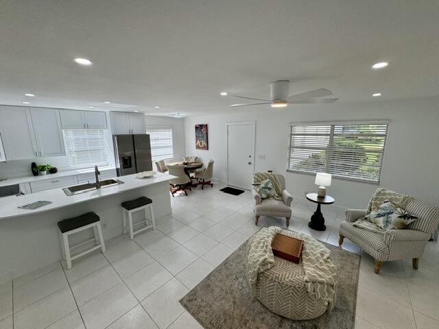 541 Normandy L Delray Beach, FL 33484 - Photo 6 of 55 a living room with furniture kitchen view and a large window