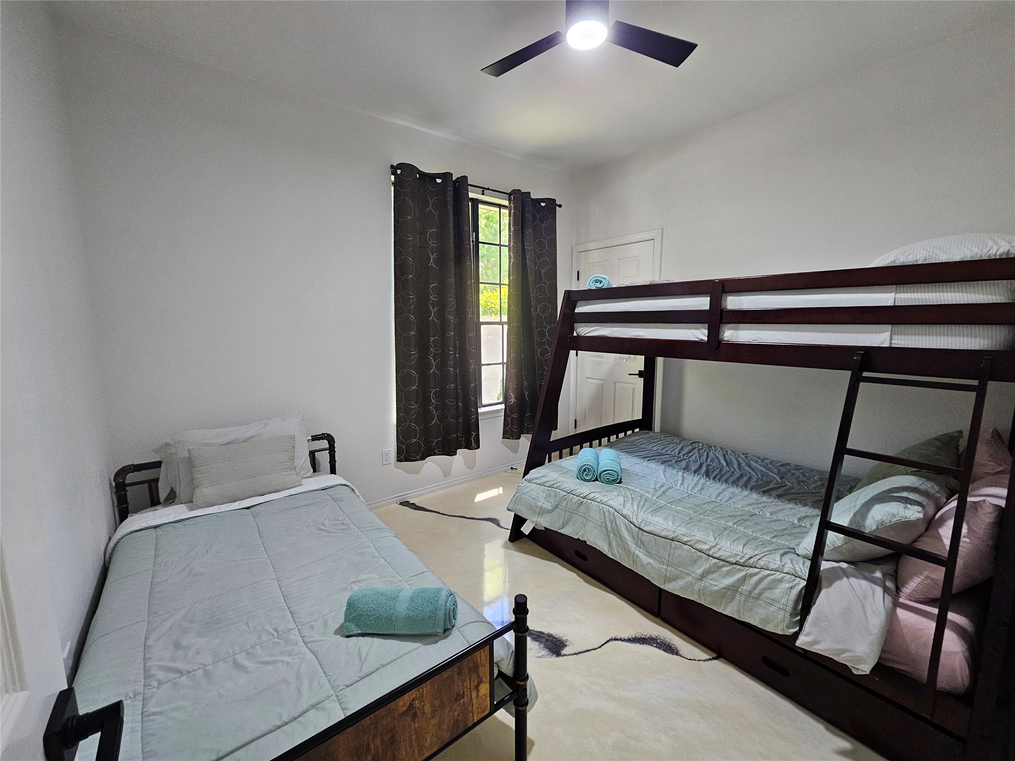 11806 Prairie Hen Lane Austin, TX 78758 - Photo 11 of 16 a bedroom with bed and window