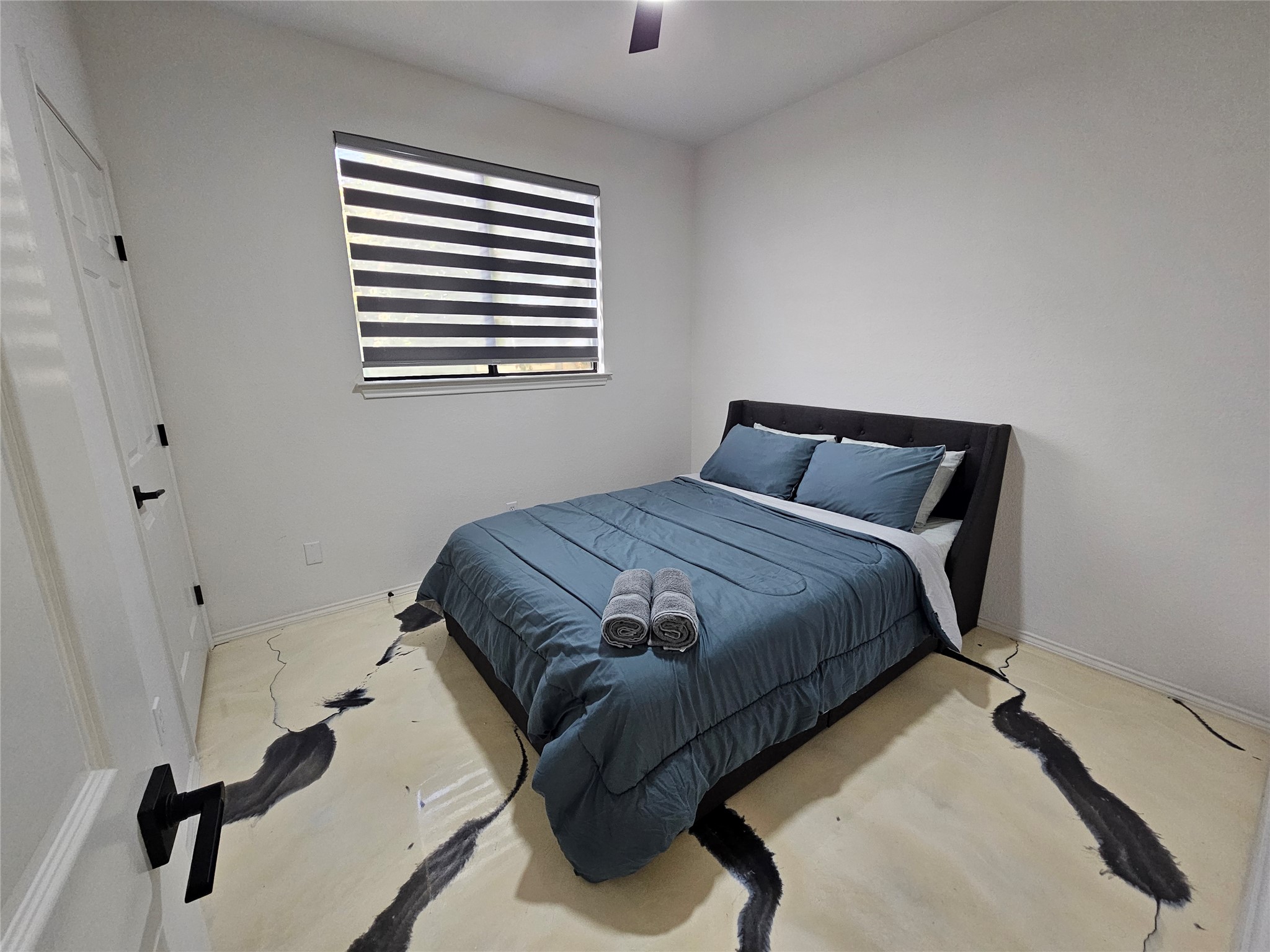 11806 Prairie Hen Lane Austin, TX 78758 - Photo 12 of 16 a bedroom with a bed and window