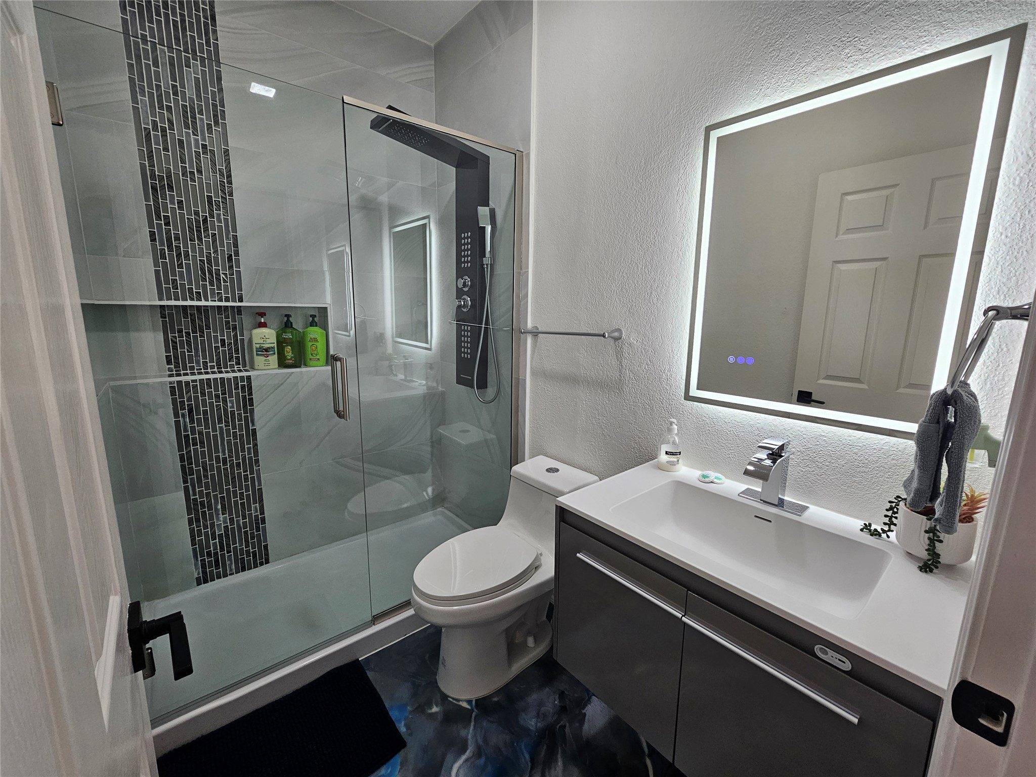 11806 Prairie Hen Lane Austin, TX 78758 - Photo 13 of 16 a bathroom with a sink a toilet a mirror and shower