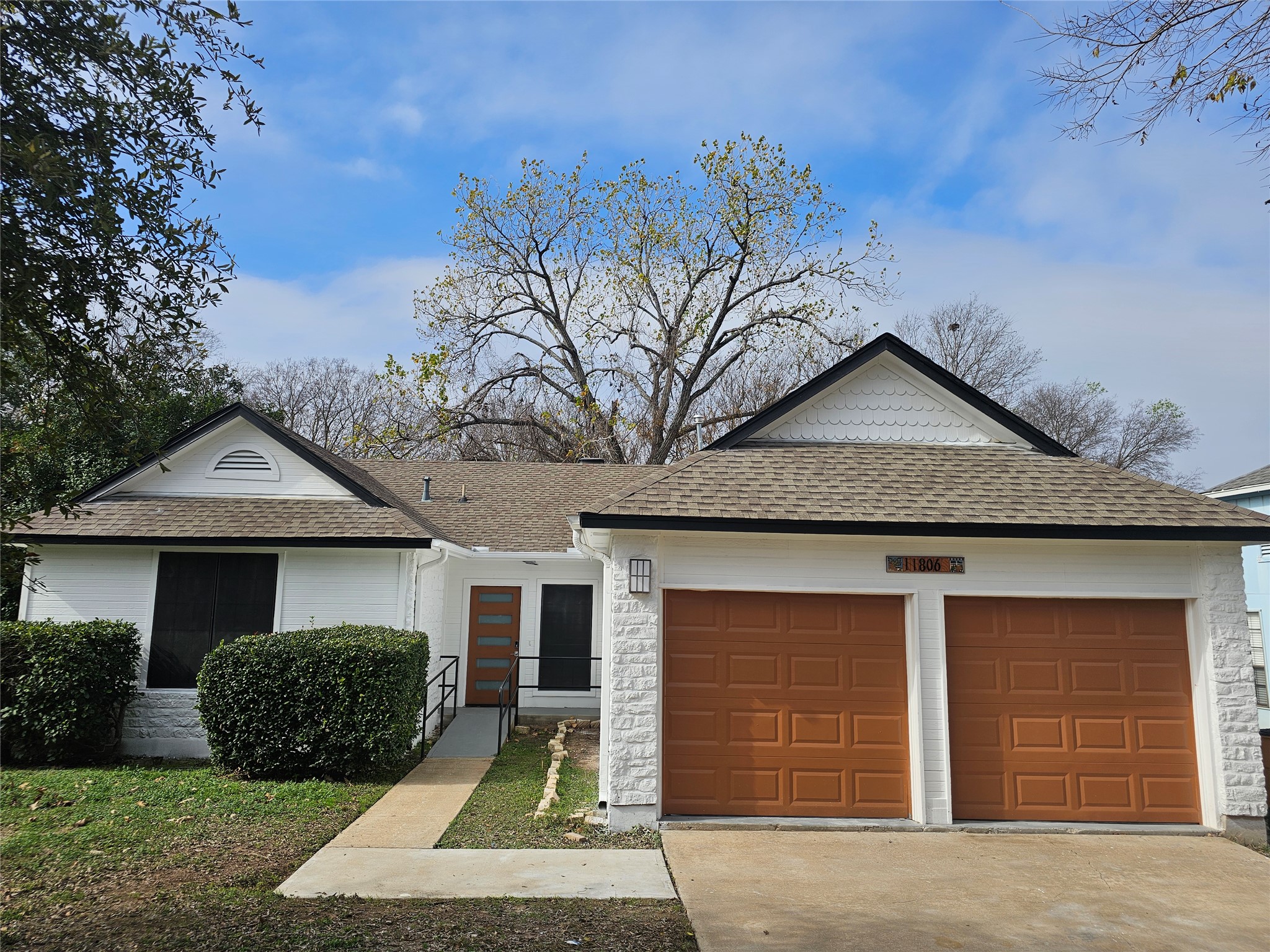 11806 Prairie Hen Lane Austin, TX 78758 - Photo 15 of 16 a front view of a house with a yard and garage