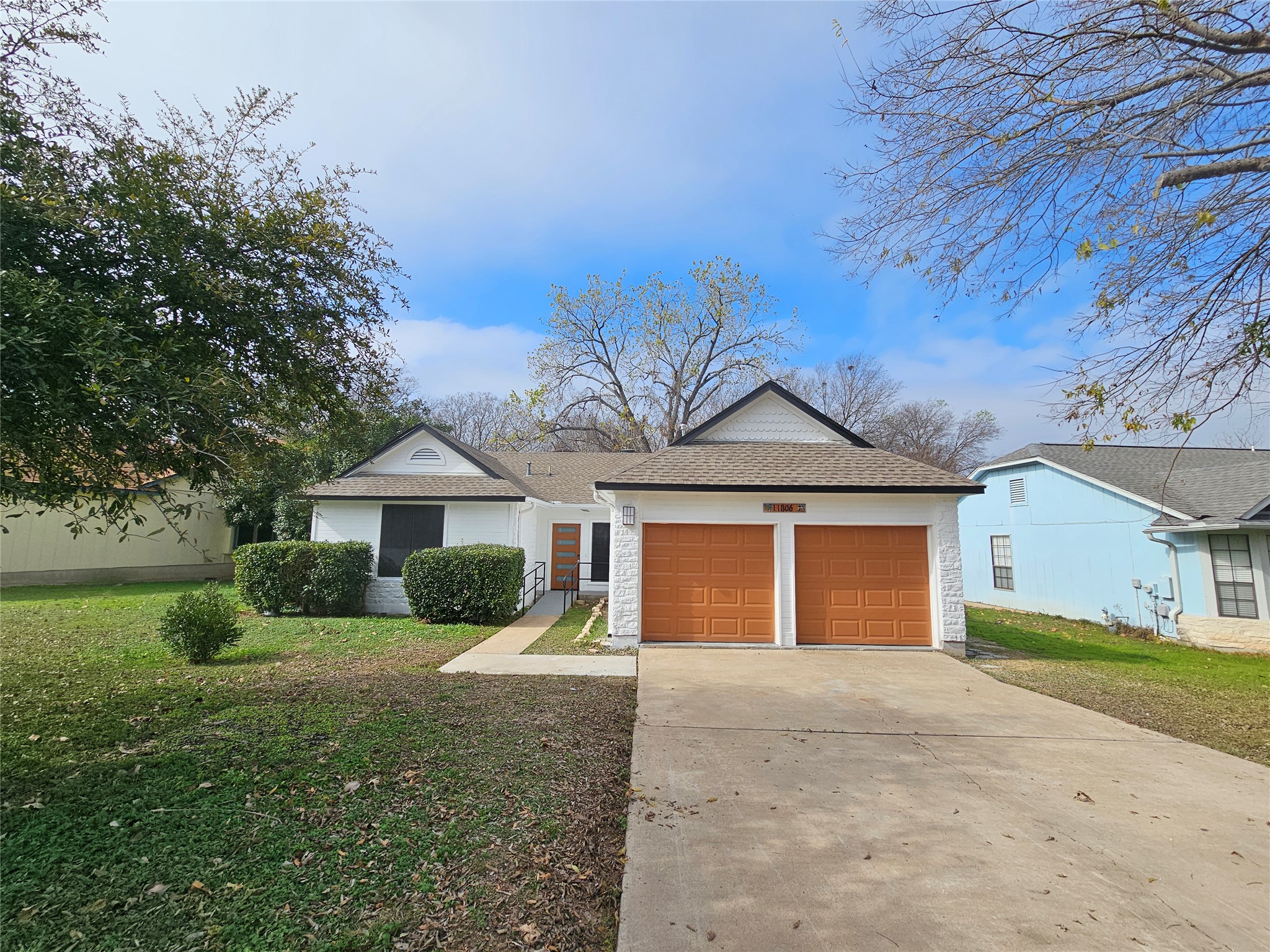 11806 Prairie Hen Lane Austin, TX 78758 - Photo 16 of 16 a front view of a house with a yard and garage