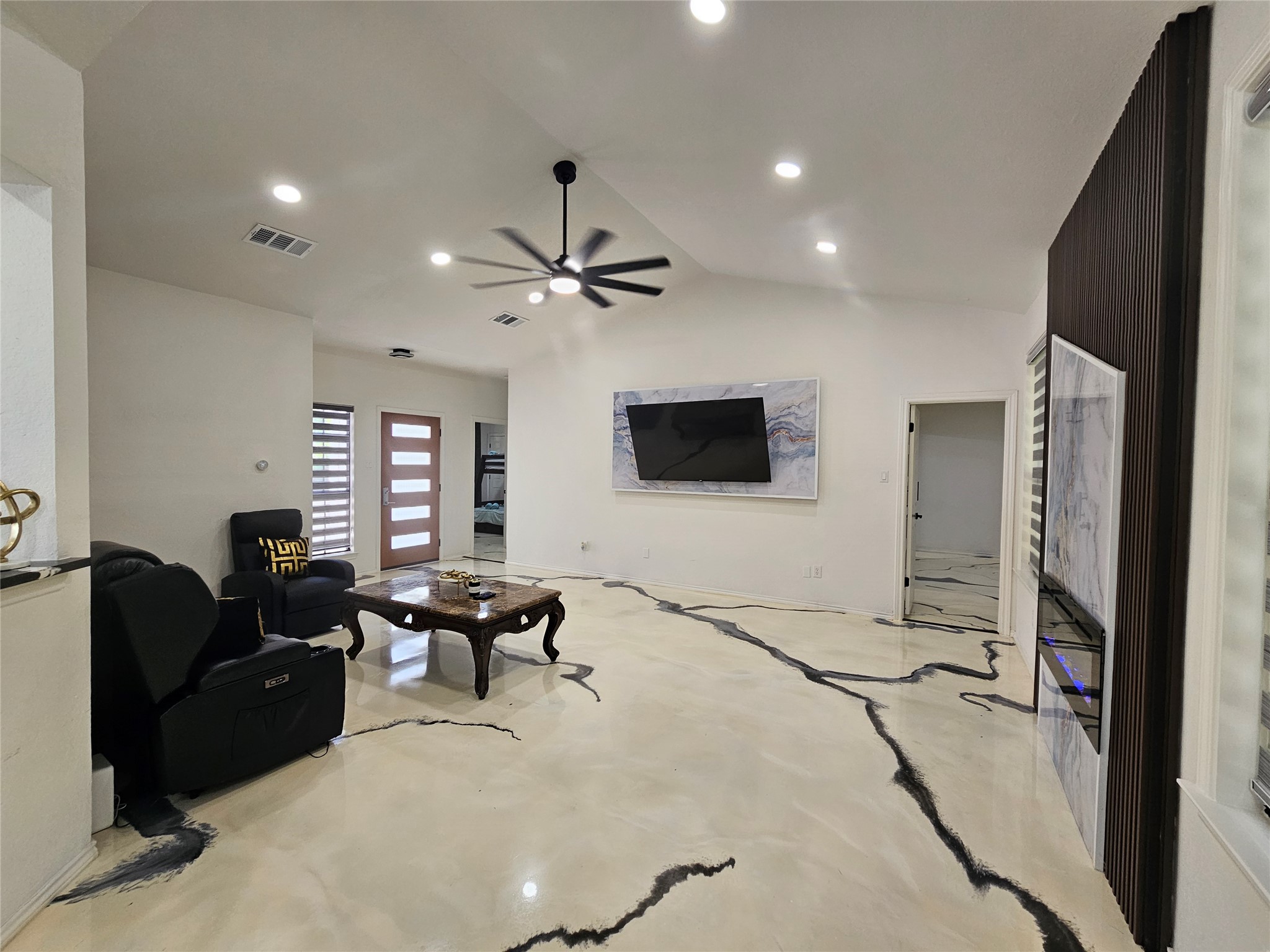 11806 Prairie Hen Lane Austin, TX 78758 - Photo 2 of 16 a living room with furniture and a flat screen tv
