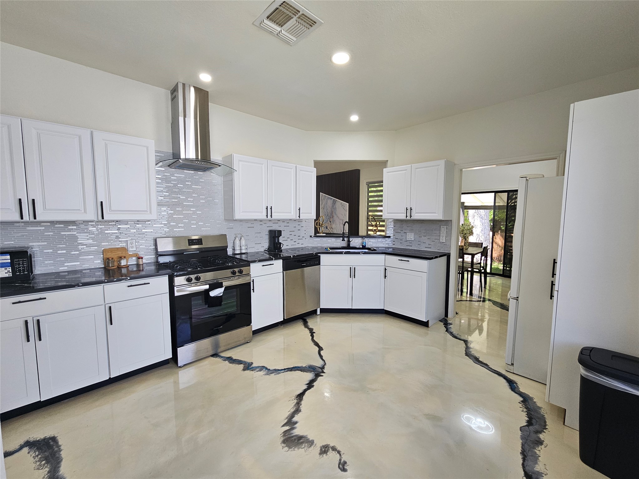 11806 Prairie Hen Lane Austin, TX 78758 - Photo 3 of 16 a kitchen with stainless steel appliances granite countertop a sink counter space cabinets and a stove