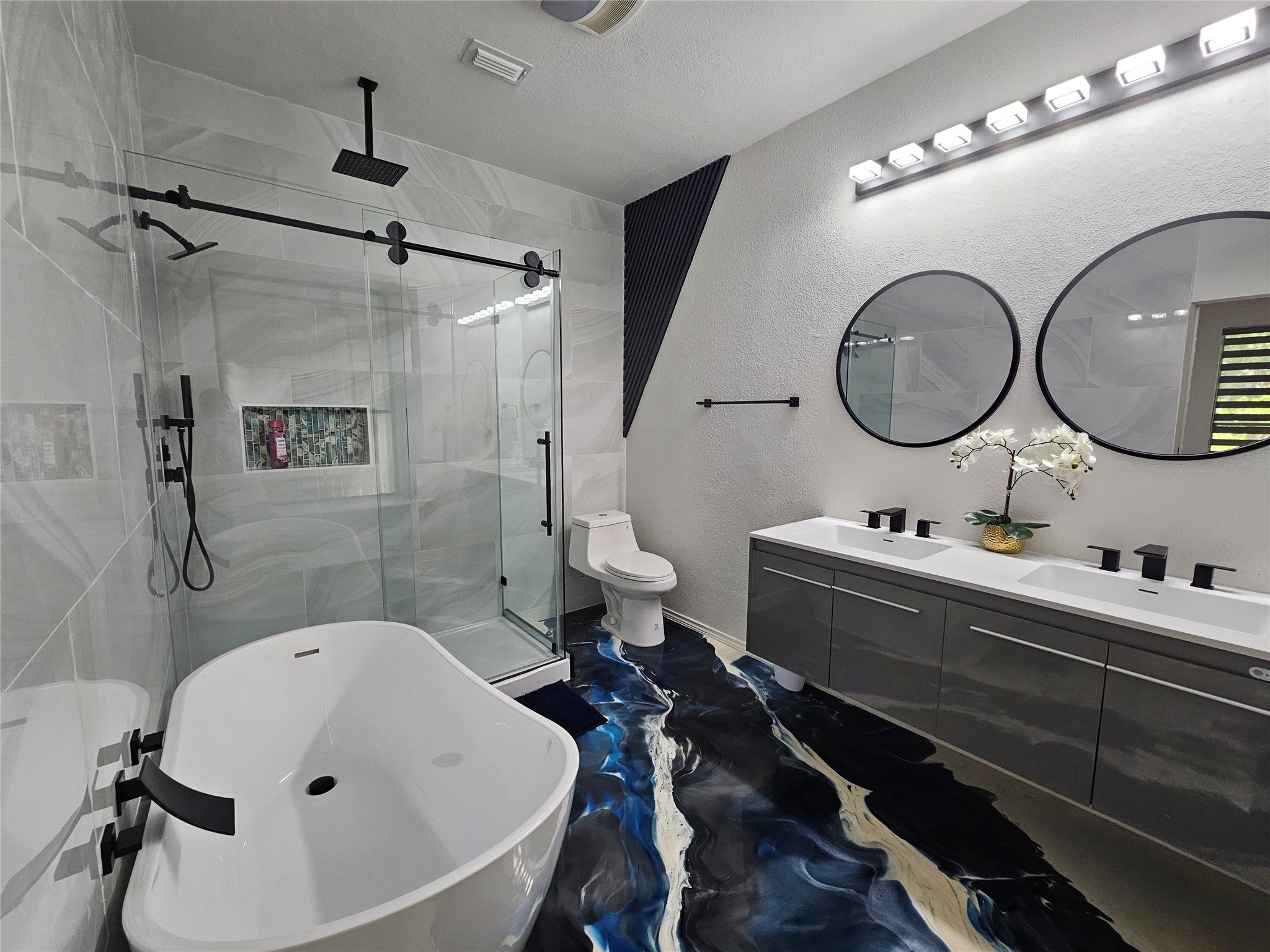 11806 Prairie Hen Lane Austin, TX 78758 - Photo 7 of 16 a bathroom with a double vanity sink mirror and shower