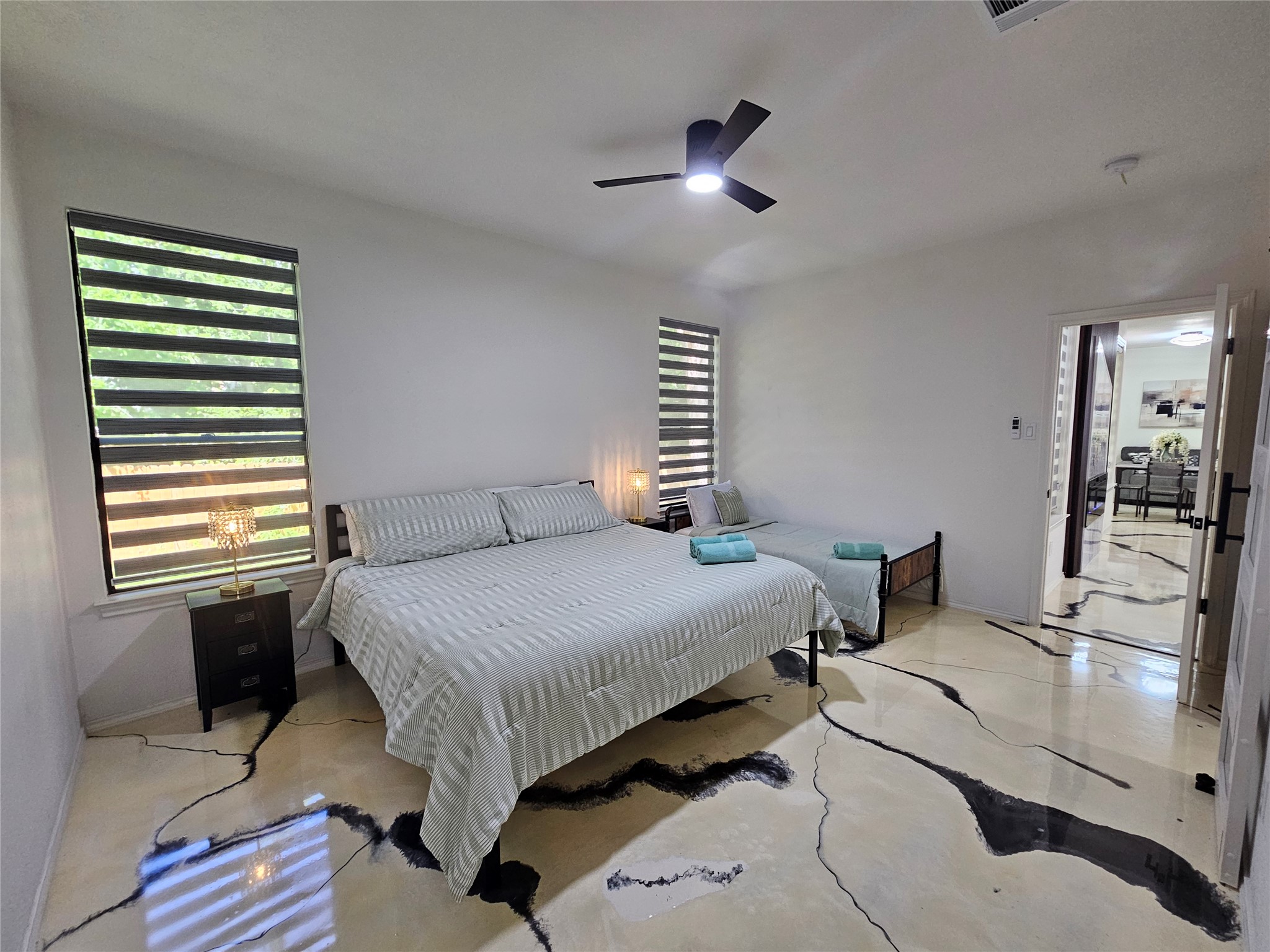 11806 Prairie Hen Lane Austin, TX 78758 - Photo 8 of 16 a bedroom with a bed and a chandelier