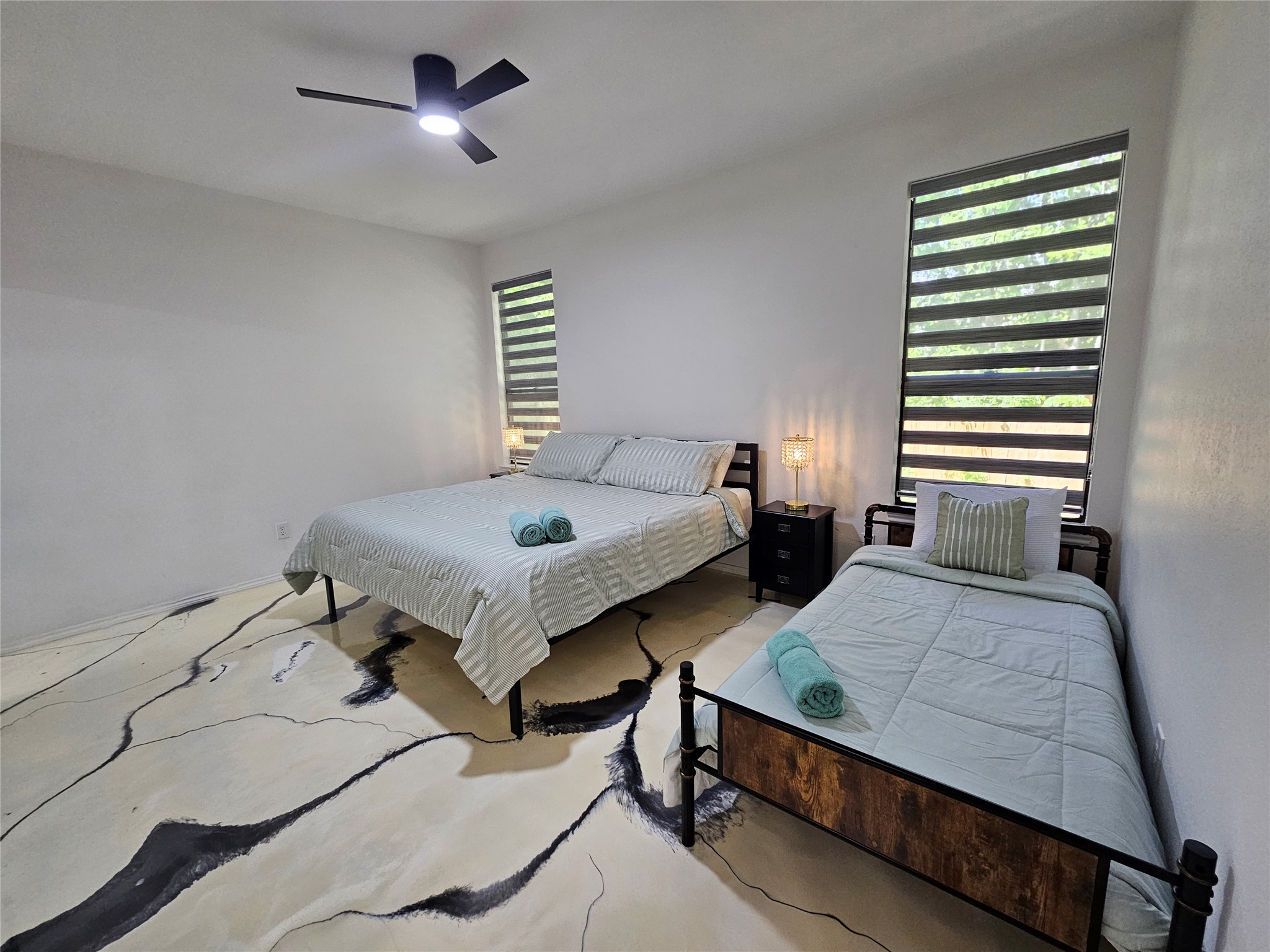 11806 Prairie Hen Lane Austin, TX 78758 - Photo 9 of 16 a bedroom with two beds and a window