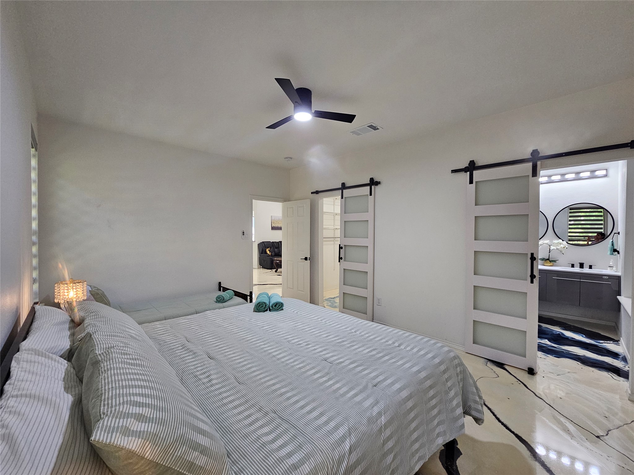 11806 Prairie Hen Lane Austin, TX 78758 - Photo 10 of 16 a bedroom with a bed and a chandelier