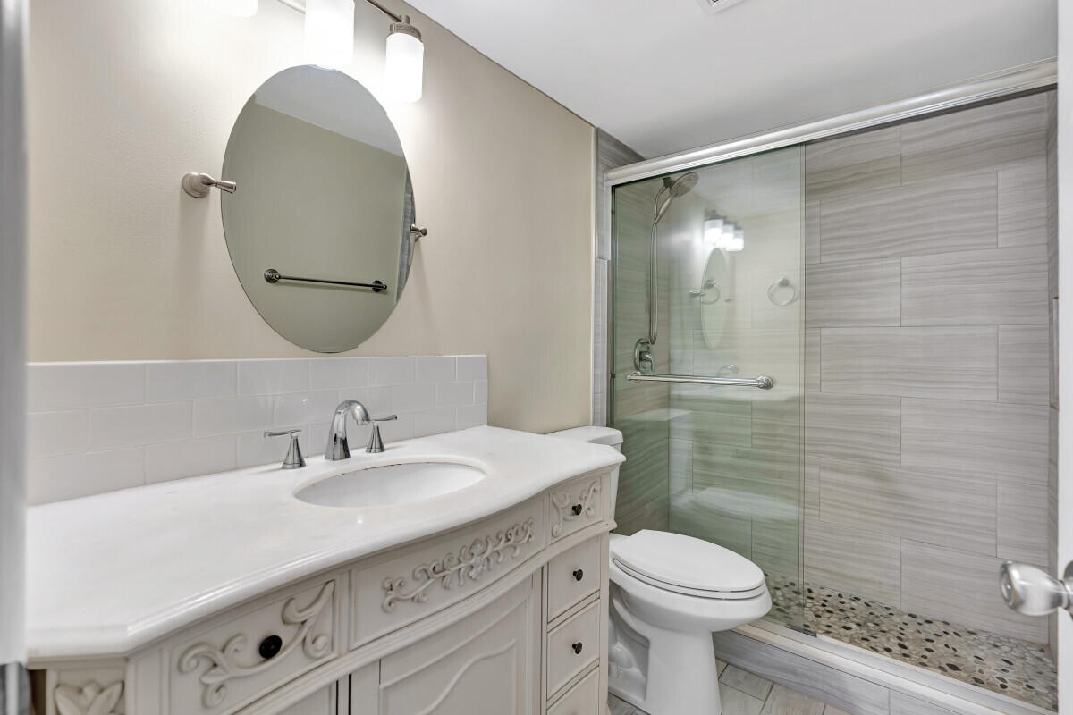 150 Pineview Road, Unit B2 Jupiter, FL 33469 - Photo 11 of 13 a bathroom with a sink toilet and shower