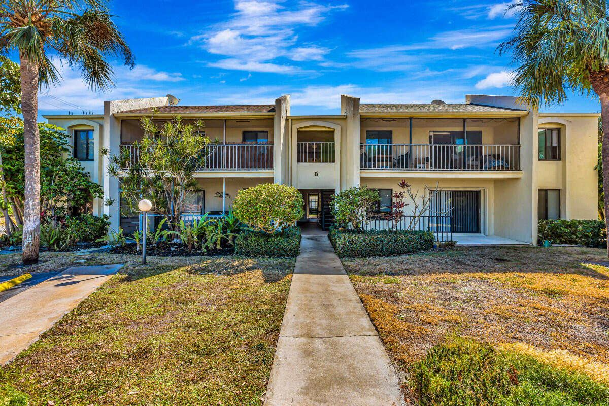 150 Pineview Road, Unit B2 Jupiter, FL 33469 - Photo 2 of 13 a front view of house with yard
